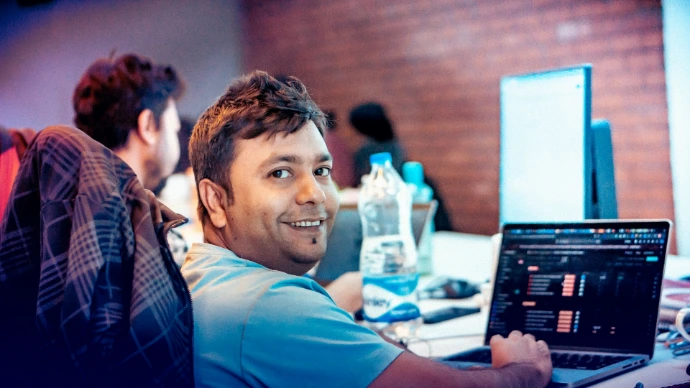 A man sitting in front of a laptop computer